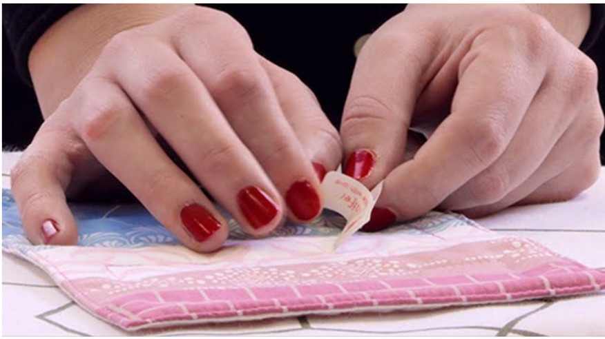 Person applying label.